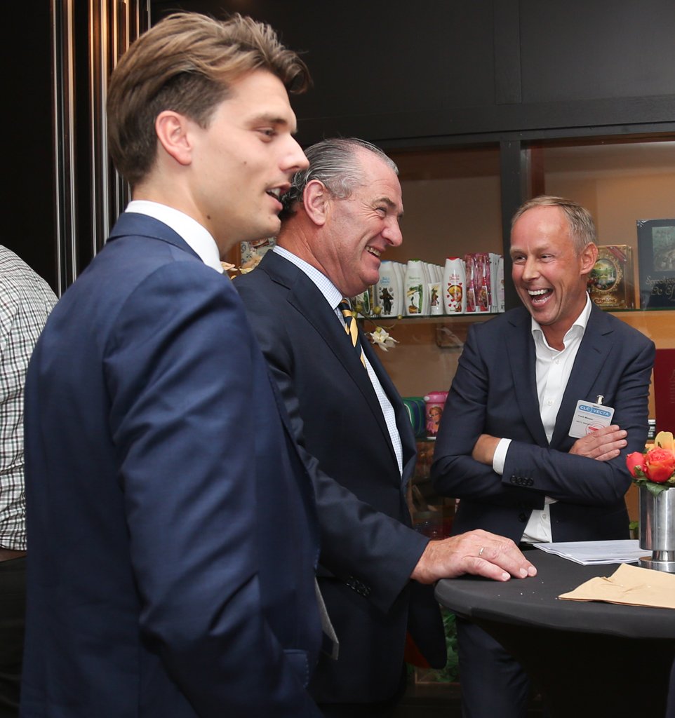 Group of attendees listening attentively during an event presentation in The Hague.