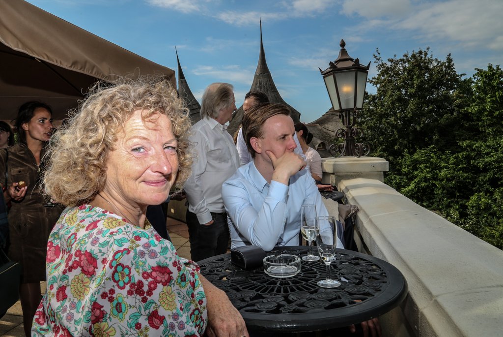 Large printed exhibition stand featuring a cityscape image at an event in The Hague.