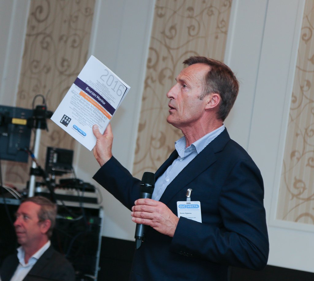 Audience members reacting with laughter and smiles during an event in The Hague.