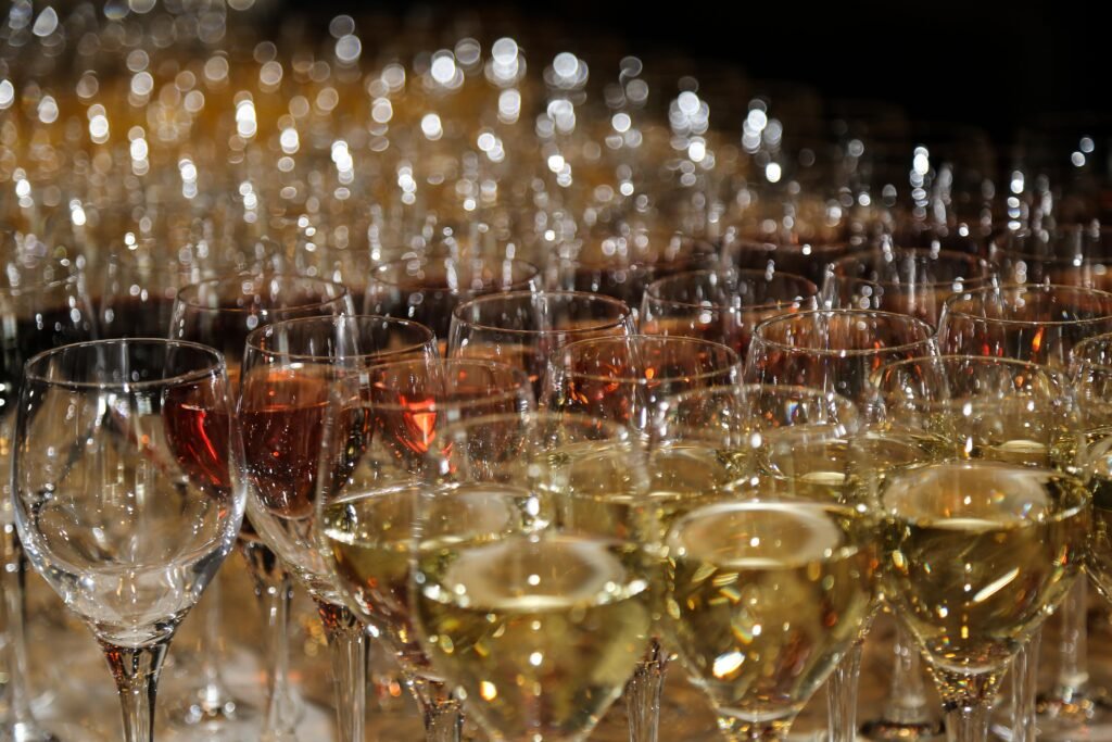 Close-up of rows of wine glasses filled for a reception at a corporate event in The Hague.
