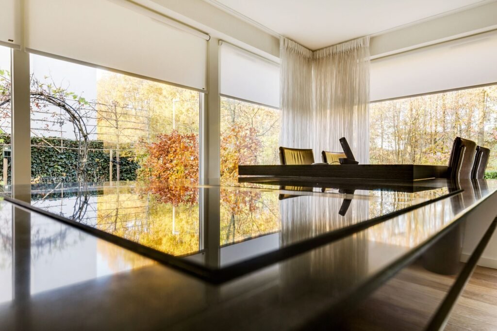 Modern dining room with panoramic windows and autumn garden view in The Hague home