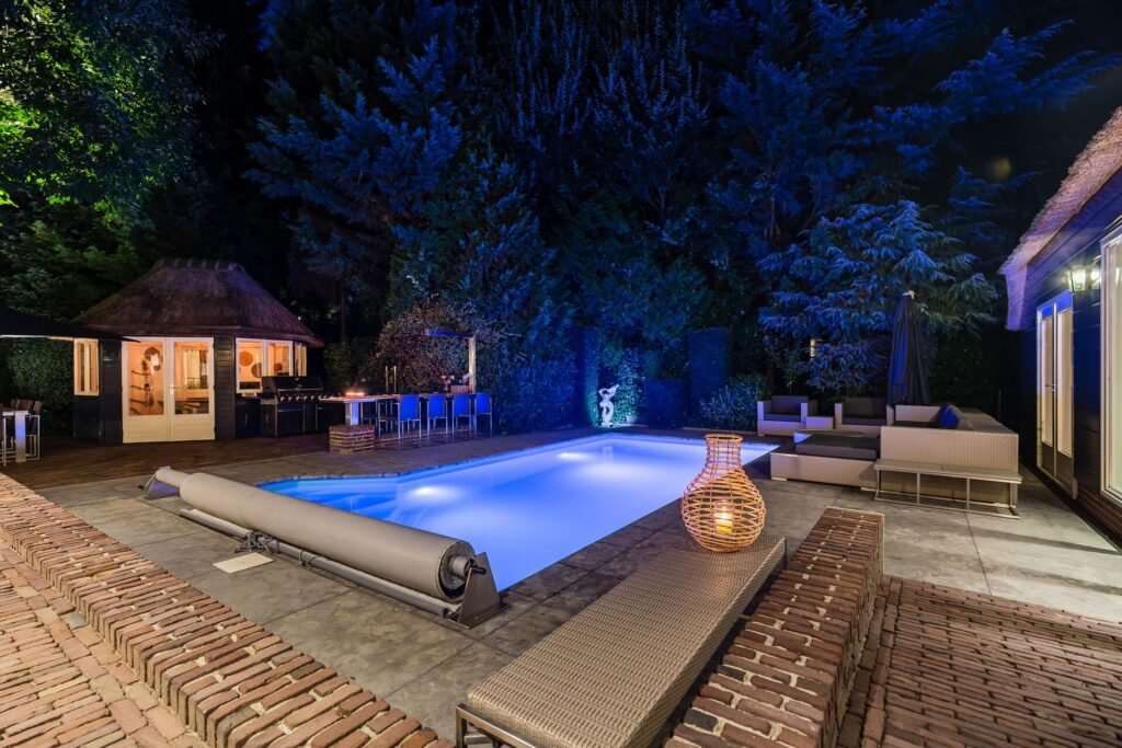 Luxury outdoor pool area illuminated at night in a The Hague villa